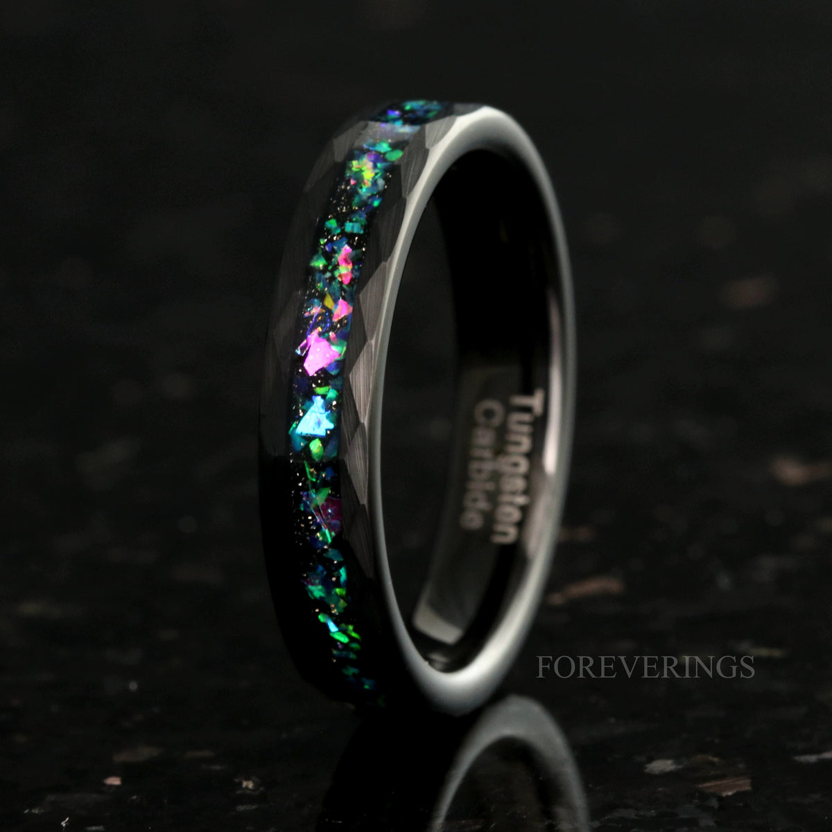 Women's 4mm hammered black tungsten ring with galaxy opal inlay, standing upright