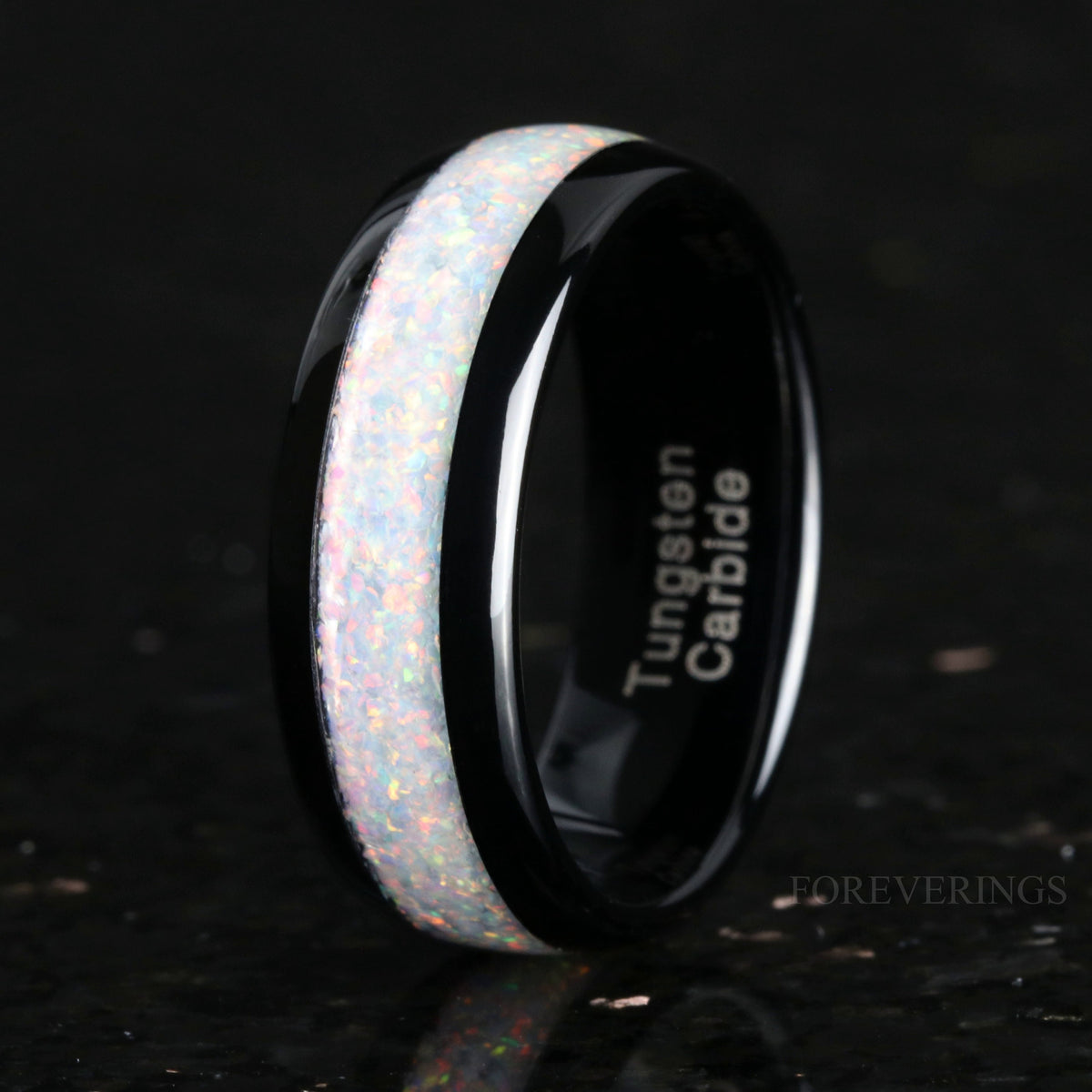 Men's 8mm black tungsten band with white fire opal inlay, angled to show the inside