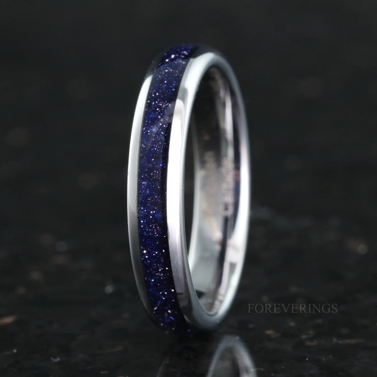 Women's 4mm silver tungsten band with blue sandstone inlay, standing upright