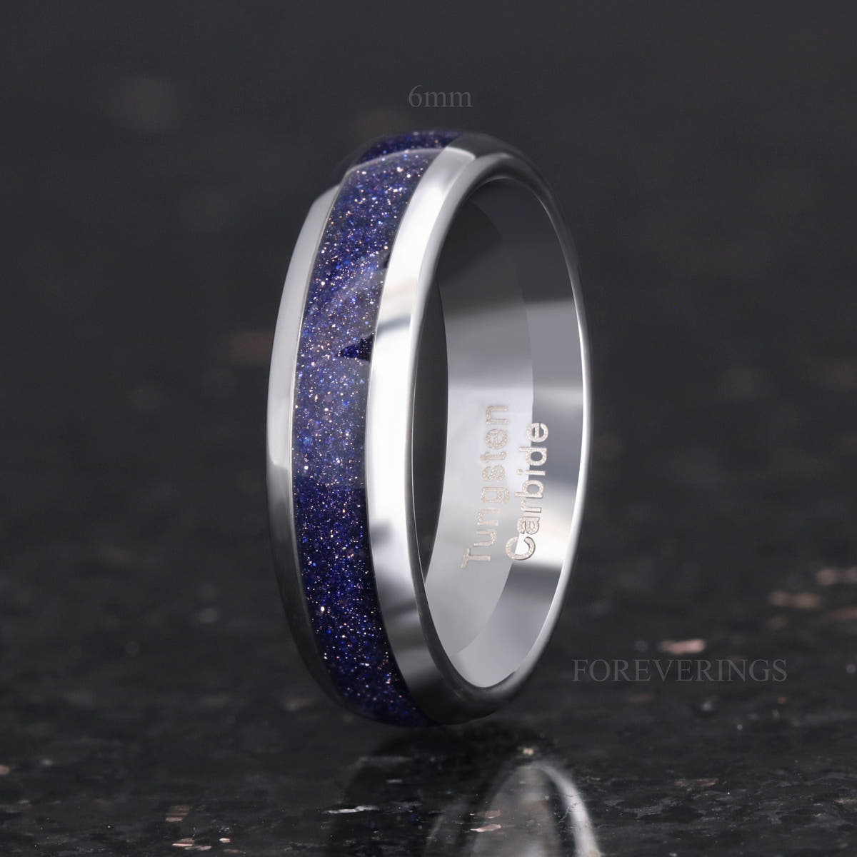 Men's 6mm silver tungsten band with blue sandstone inlay, angled to show the interior