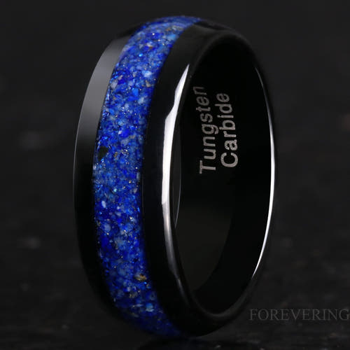 Men's 8mm black tungsten ring with crushed lapis lazuli inlay, angled close-up