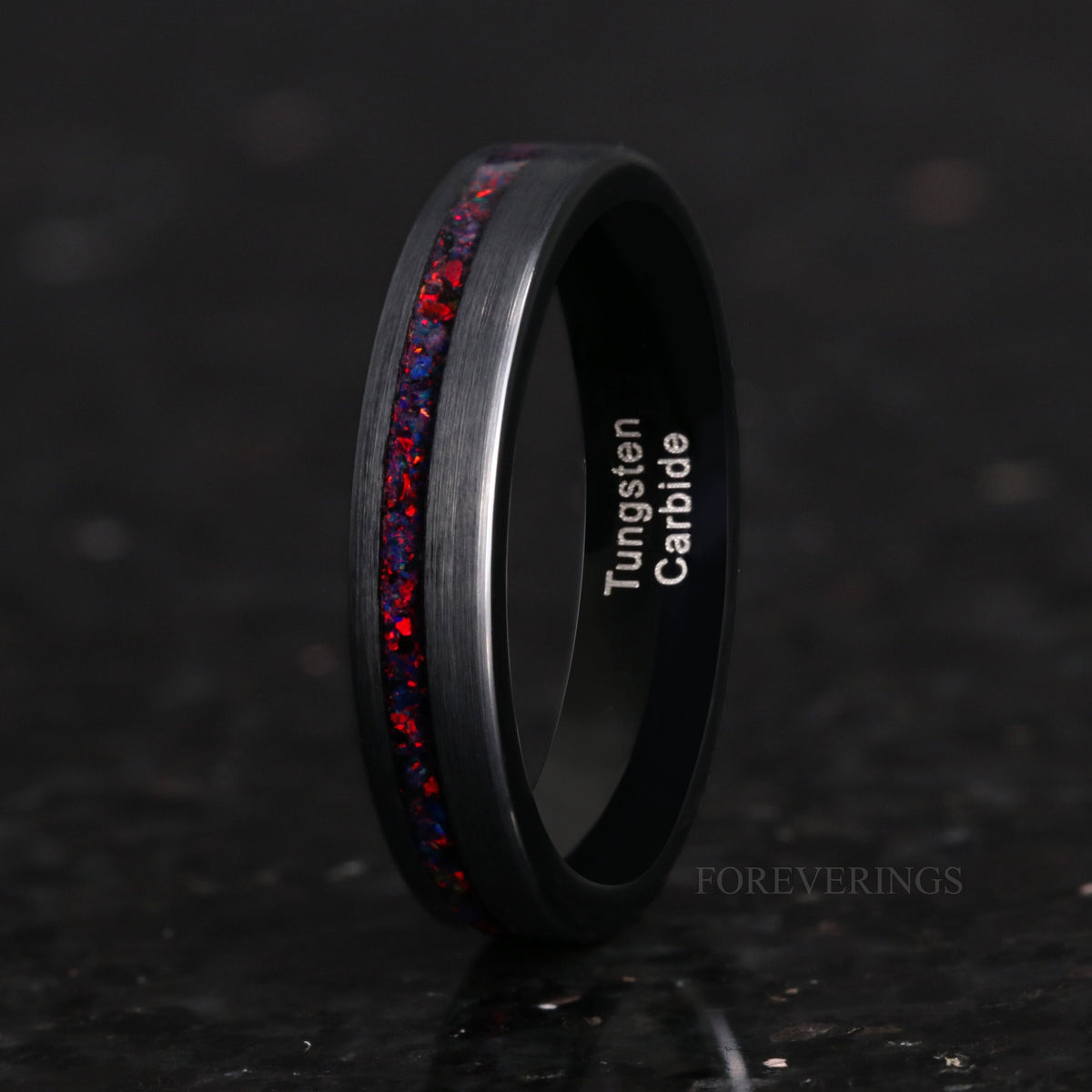 Women's 4mm black tungsten ring with black fire opal inlay, standing upright