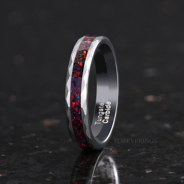 Women's 4mm hammered silver tungsten ring with black fire opal inlay, standing at an angle