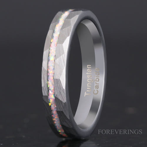 4mm hammered silver tungsten ring with an offset white fire opal strip, standing on edge in a close crop