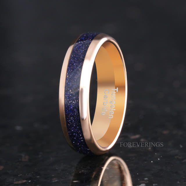 Men's 6mm rose gold tungsten band with Great Rift blue sandstone inlay, angled to show the interior
