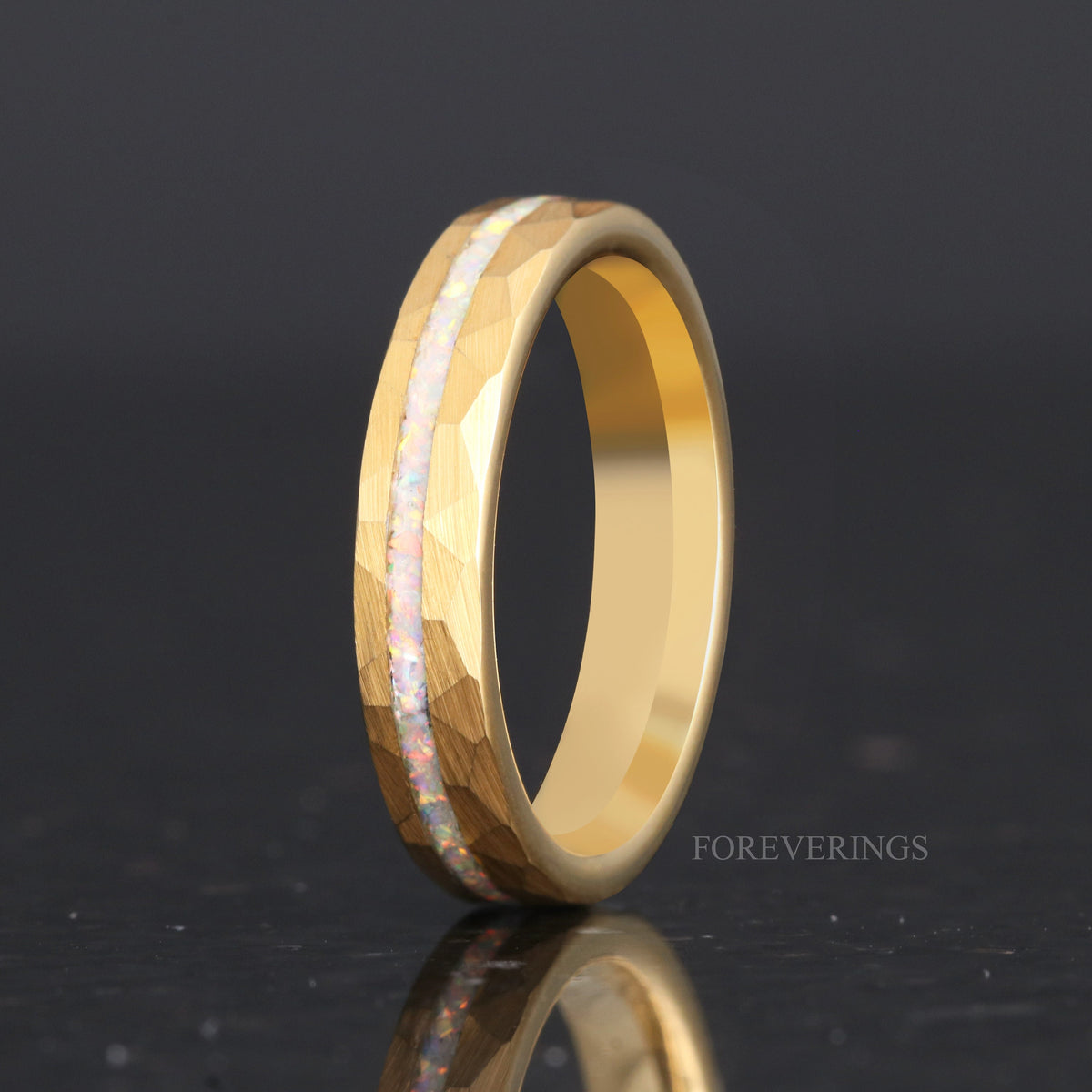 Women's 4mm hammered gold tungsten ring with white fire opal inlay, standing upright