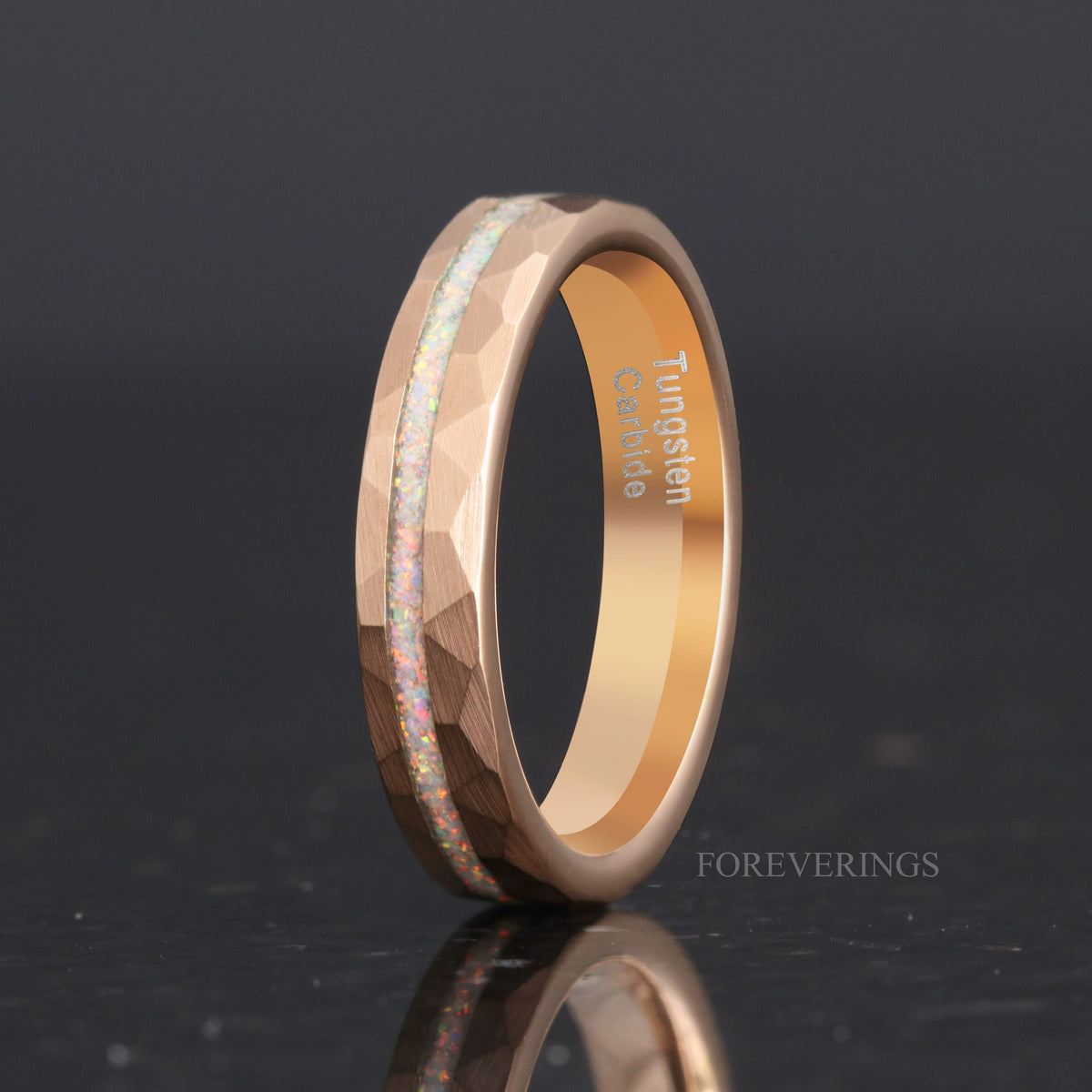 Rose gold tungsten ring with white fire opal inlay, angled to show the polished interior