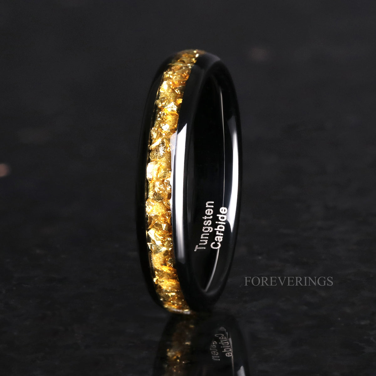 Women's 4mm black tungsten ring with crushed citrine inlay, standing on edge