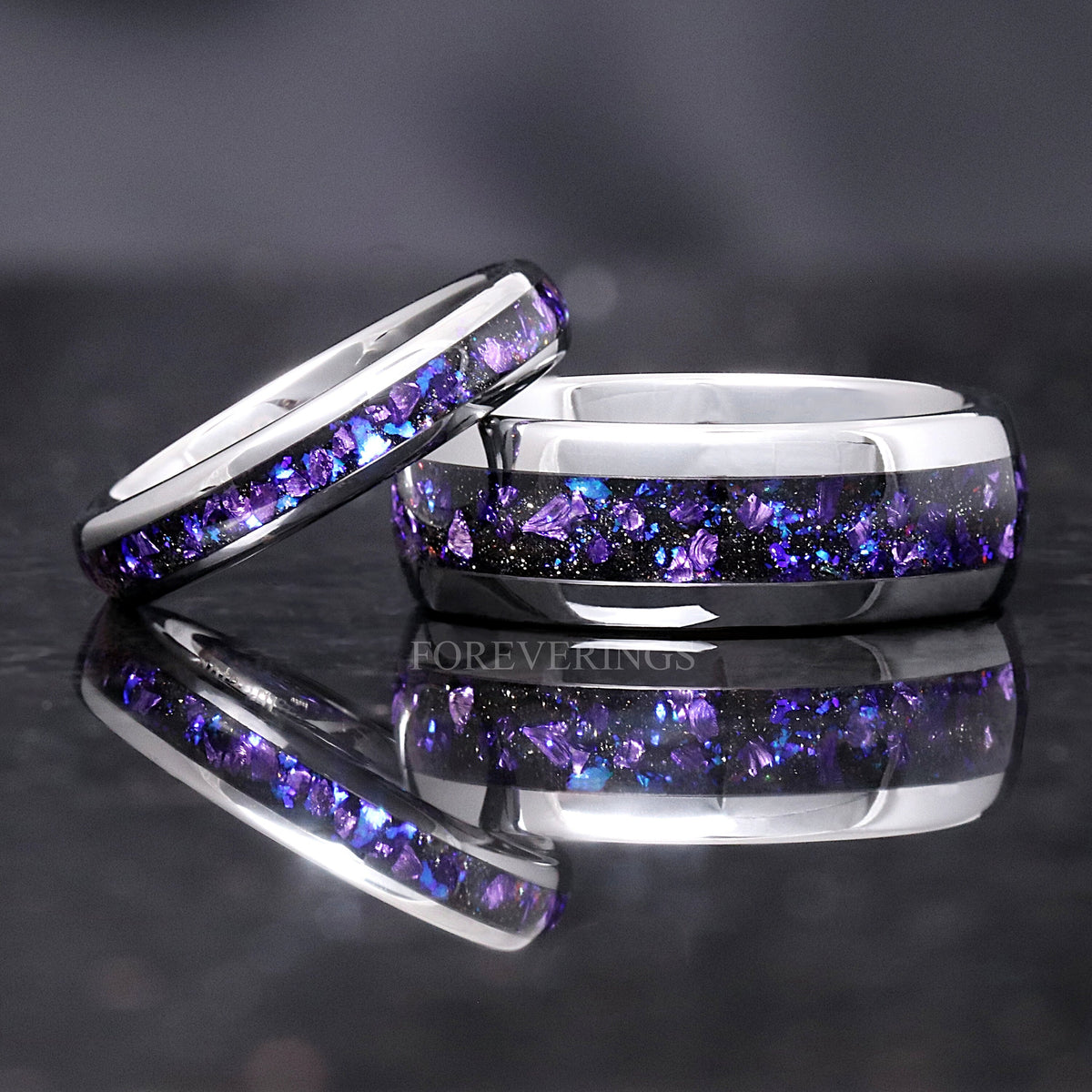 His and hers silver tungsten wedding bands with purple sandstone inlay, closer view with reflection