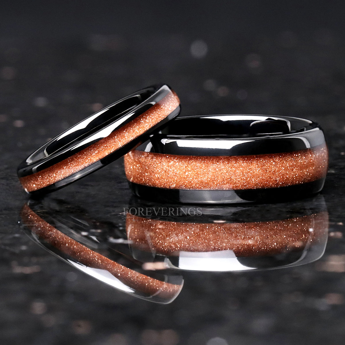 8mm black tungsten red sandstone band with a thinner band of the same inlay leaning on it