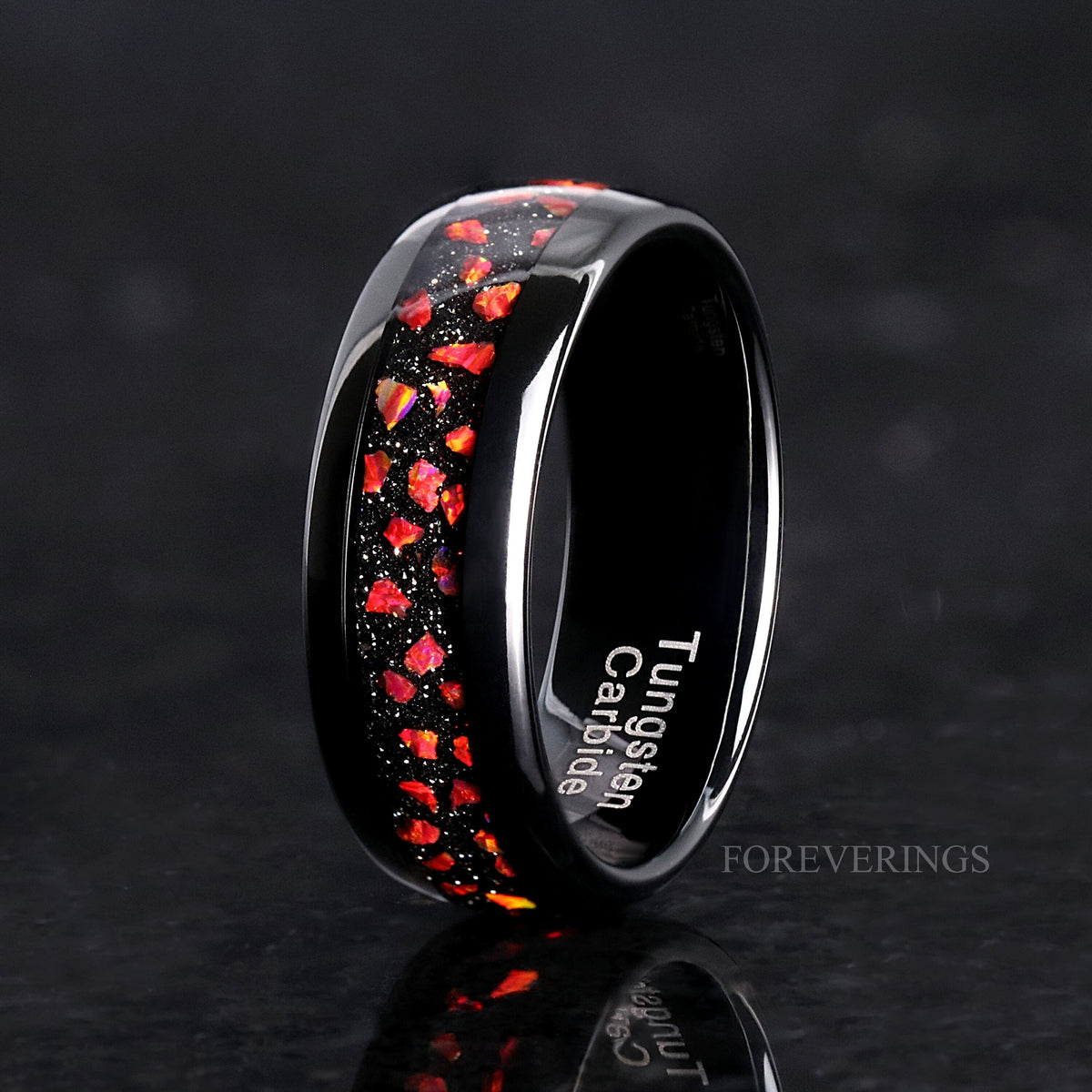 Men's 8mm black tungsten band with red fire opal inlay, angled to show the inside