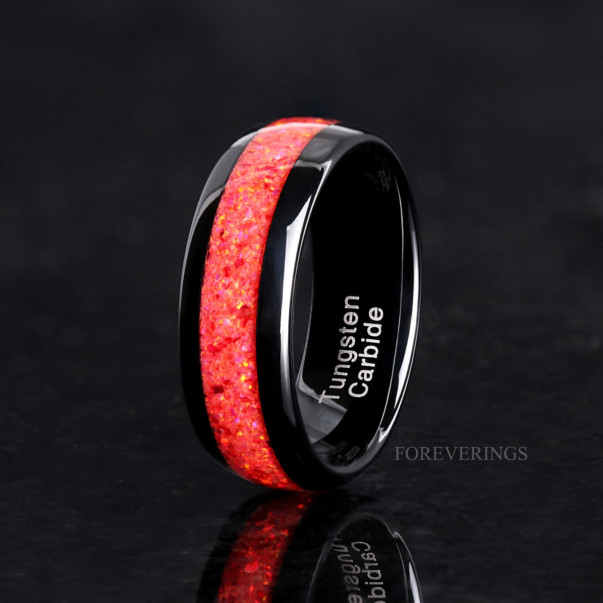 His 8mm black tungsten ring with red fire opal inlay, angled to show the polished interior