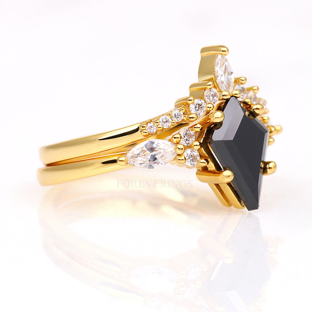 Gold kite black onyx engagement ring and curved band, angled side view