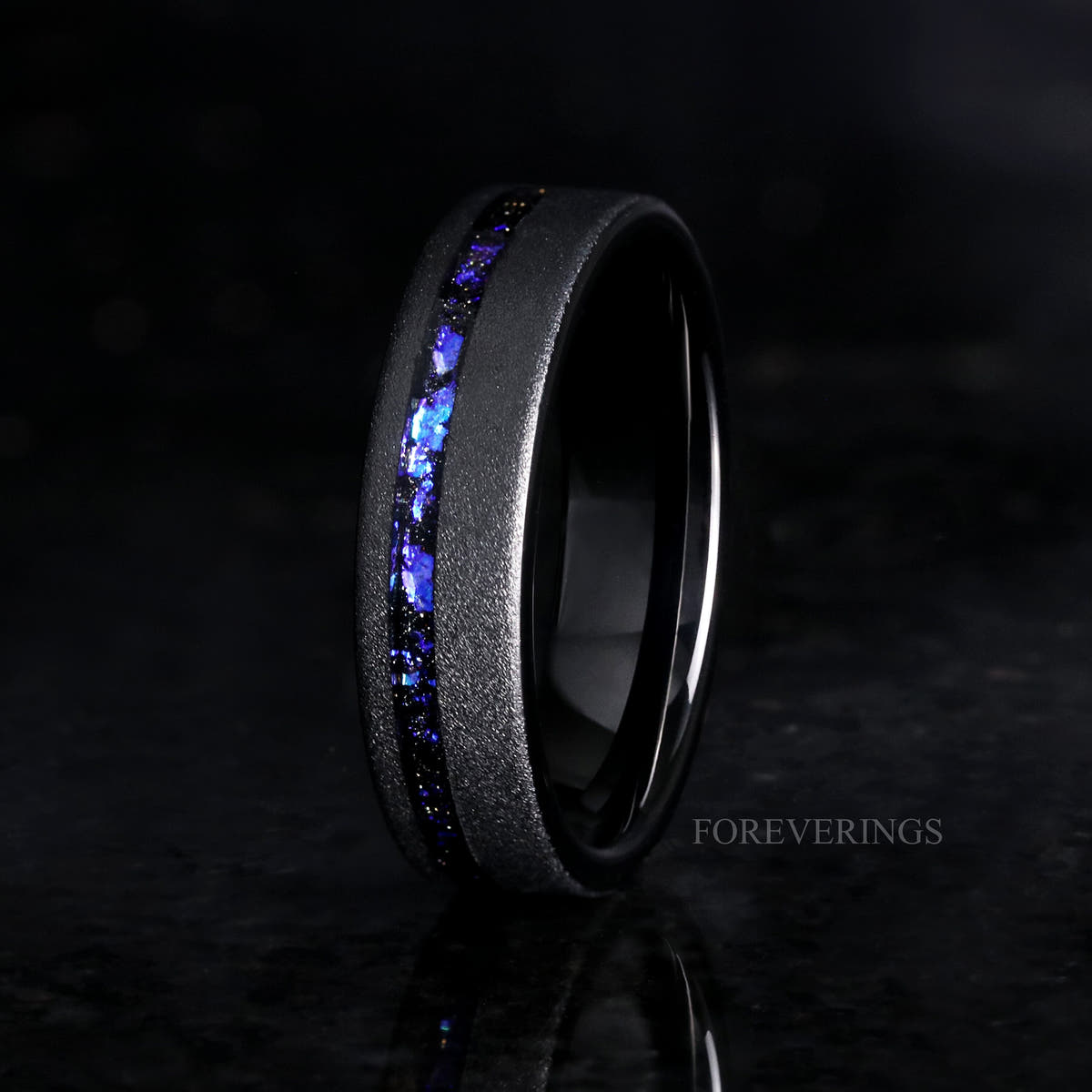 Men's 6mm sandblasted black tungsten band with nebula sandstone inlay, standing at an angle