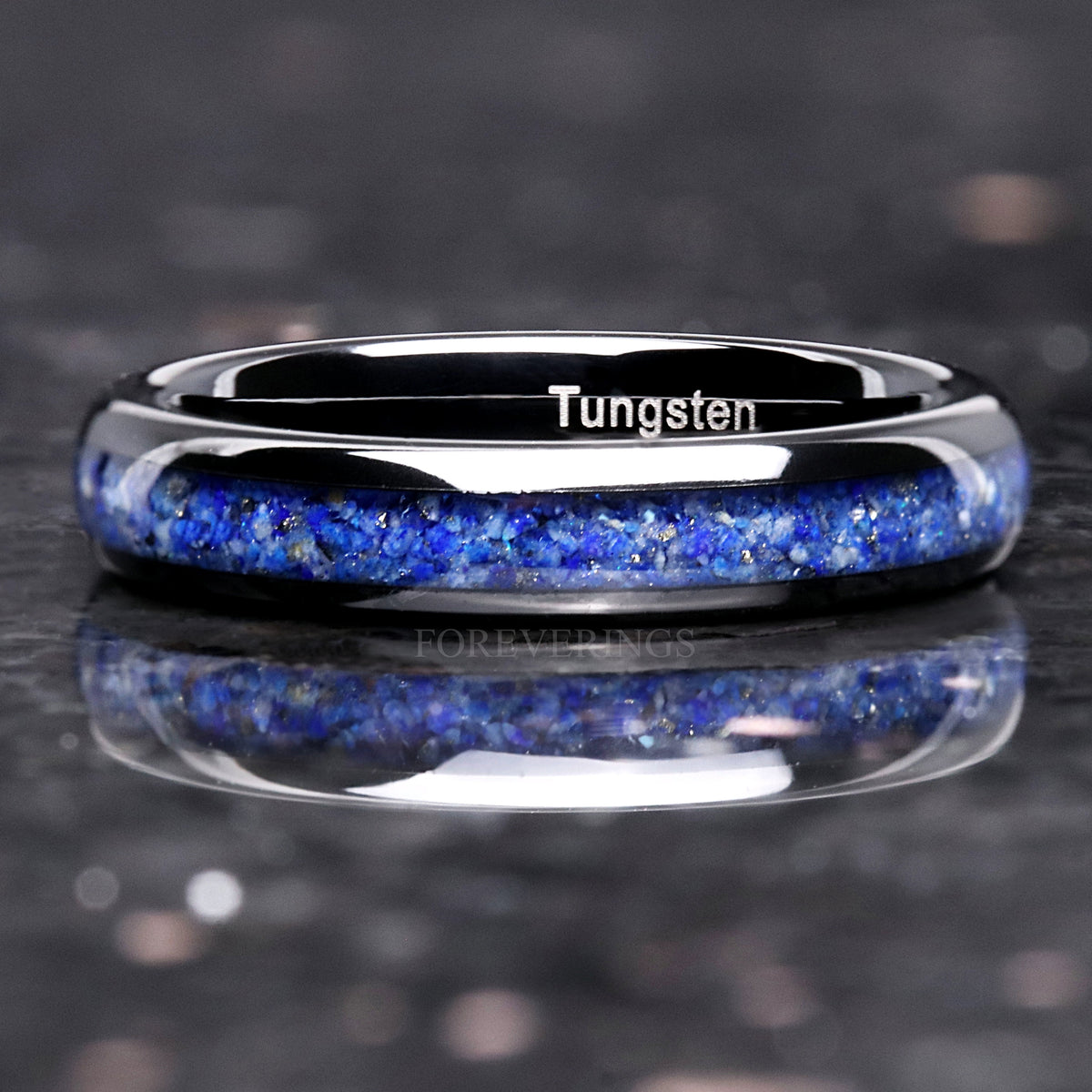 Blue lapis lazuli inlay across a black tungsten ring, shown straight on