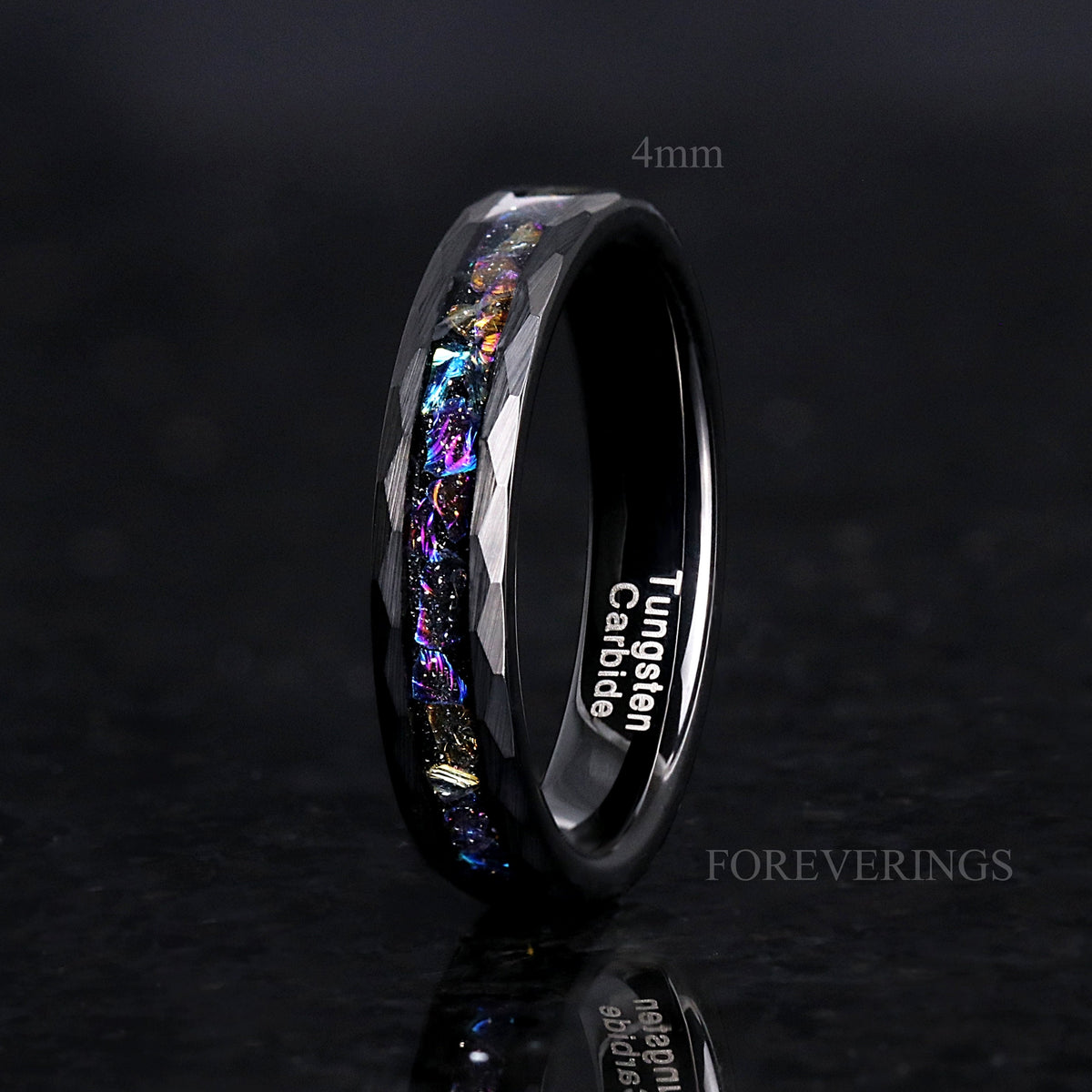 Women's 4mm black hammered tungsten ring with moonstone inlay, angled to show the inside