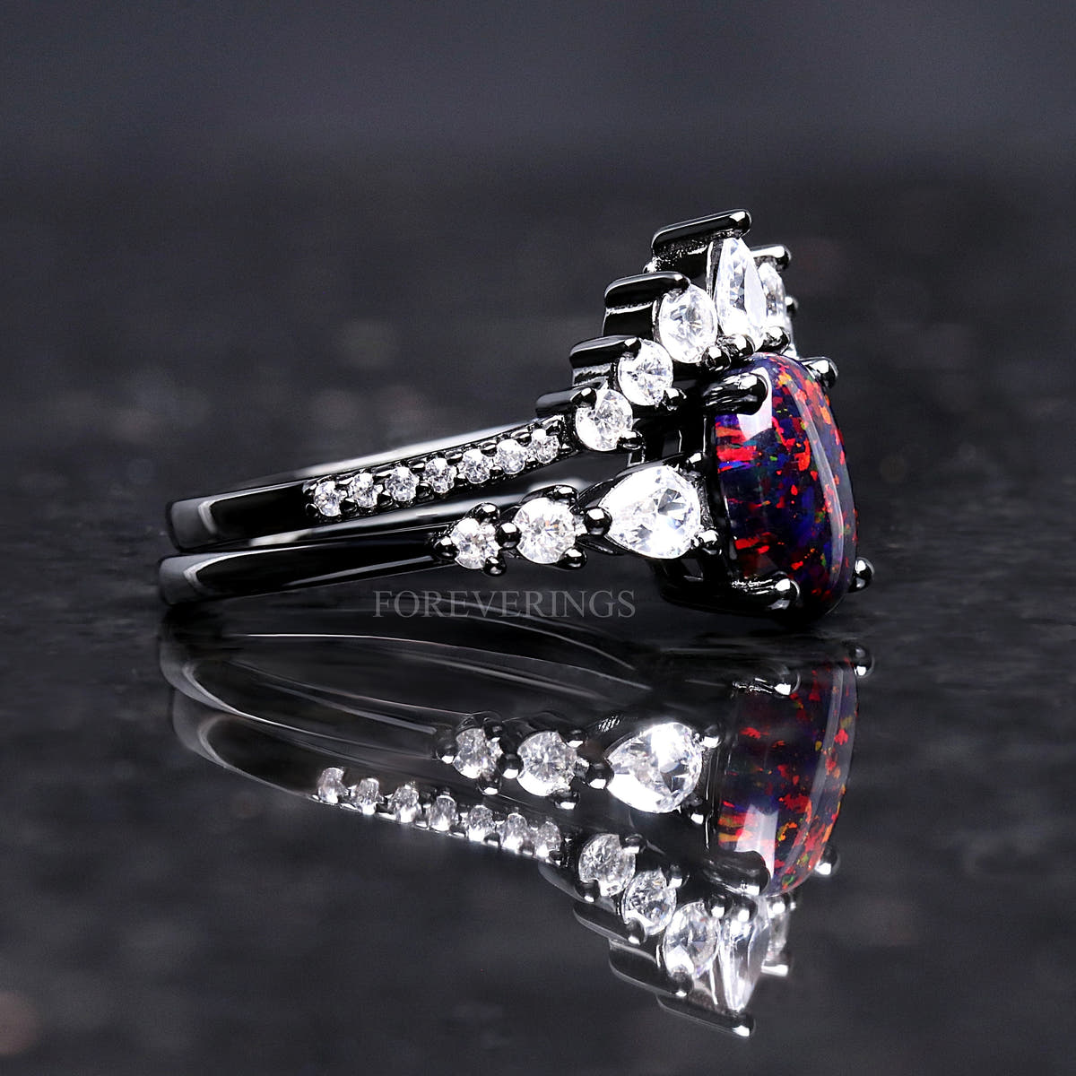 Side view of the black fire opal engagement ring and crown band in black sterling silver