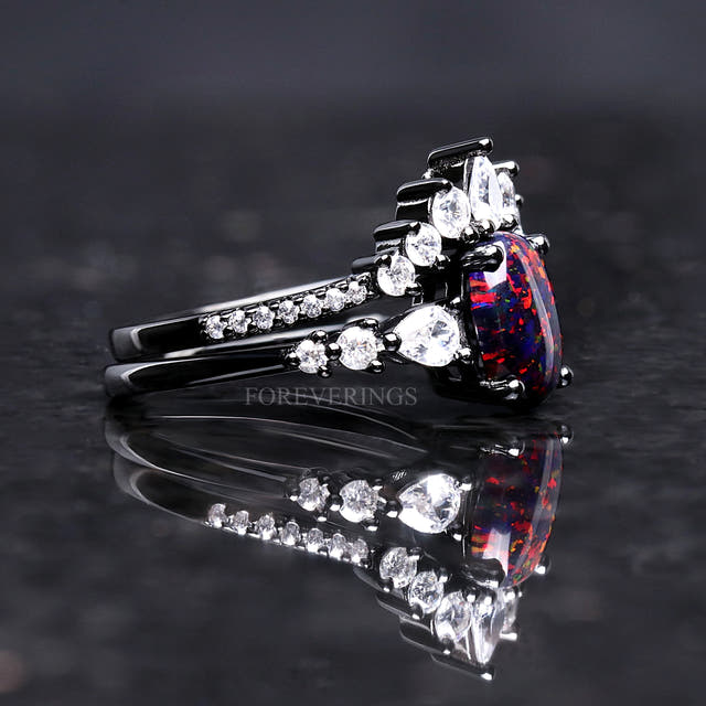 Side view of the black fire opal engagement ring and crown band in black sterling silver