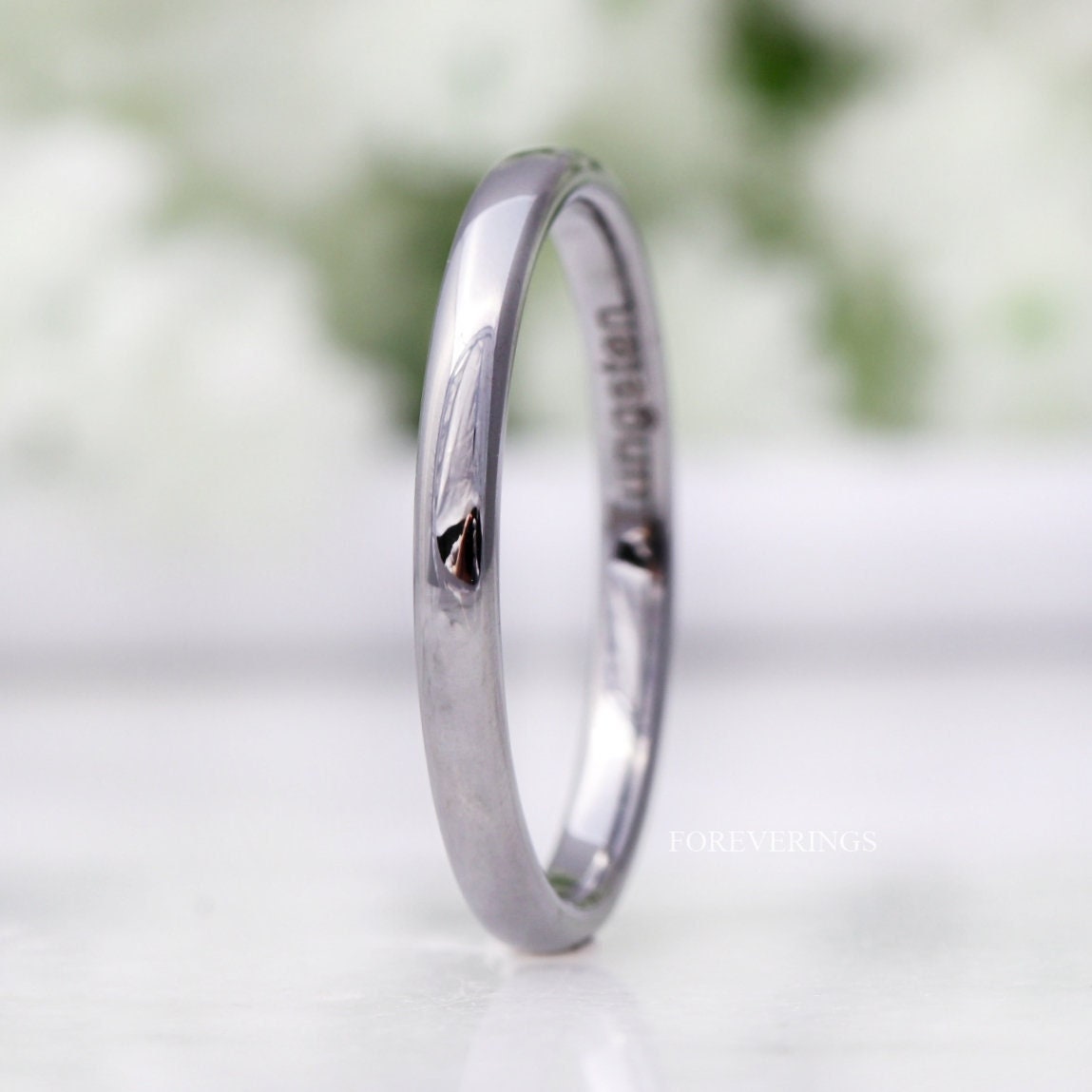 2mm domed silver tungsten band standing on edge, polished finish