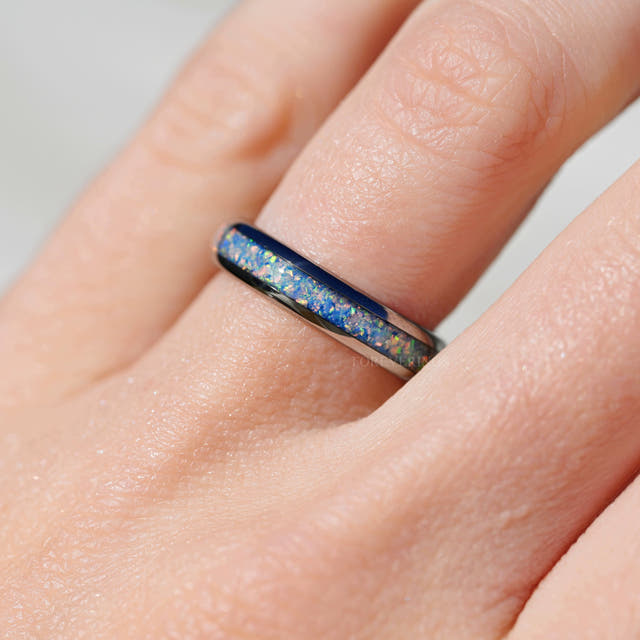 4mm silver tungsten rainbow opal ring worn on a finger