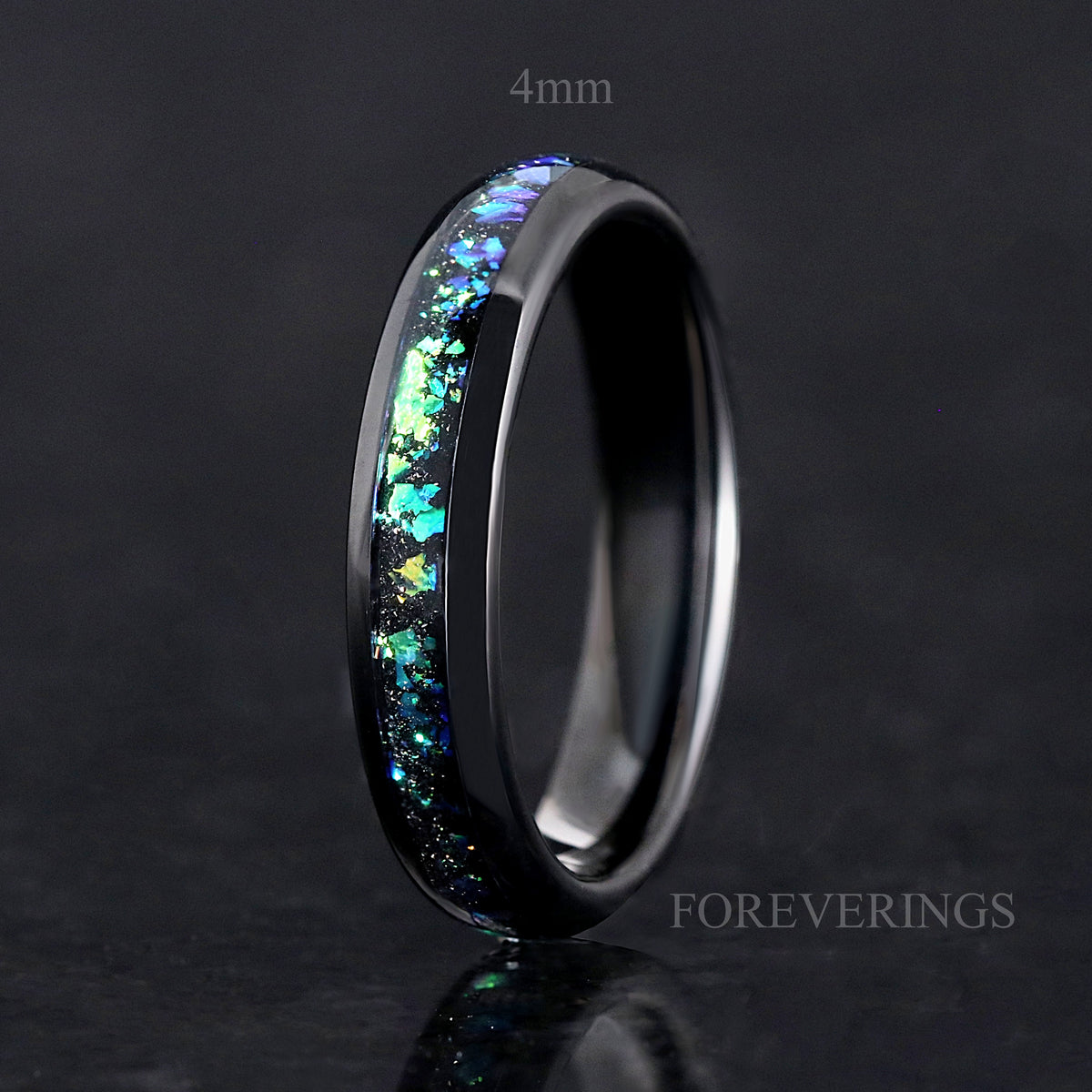 Narrow black tungsten ring labeled 4mm with teal and green nebula inlay, standing upright