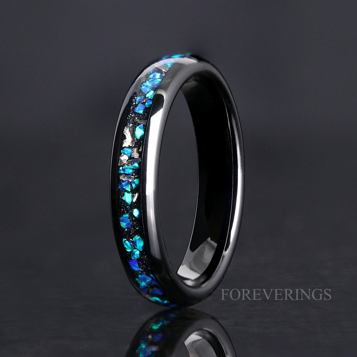 Women's 4mm black tungsten ring with blue opal and meteorite inlay, standing on edge