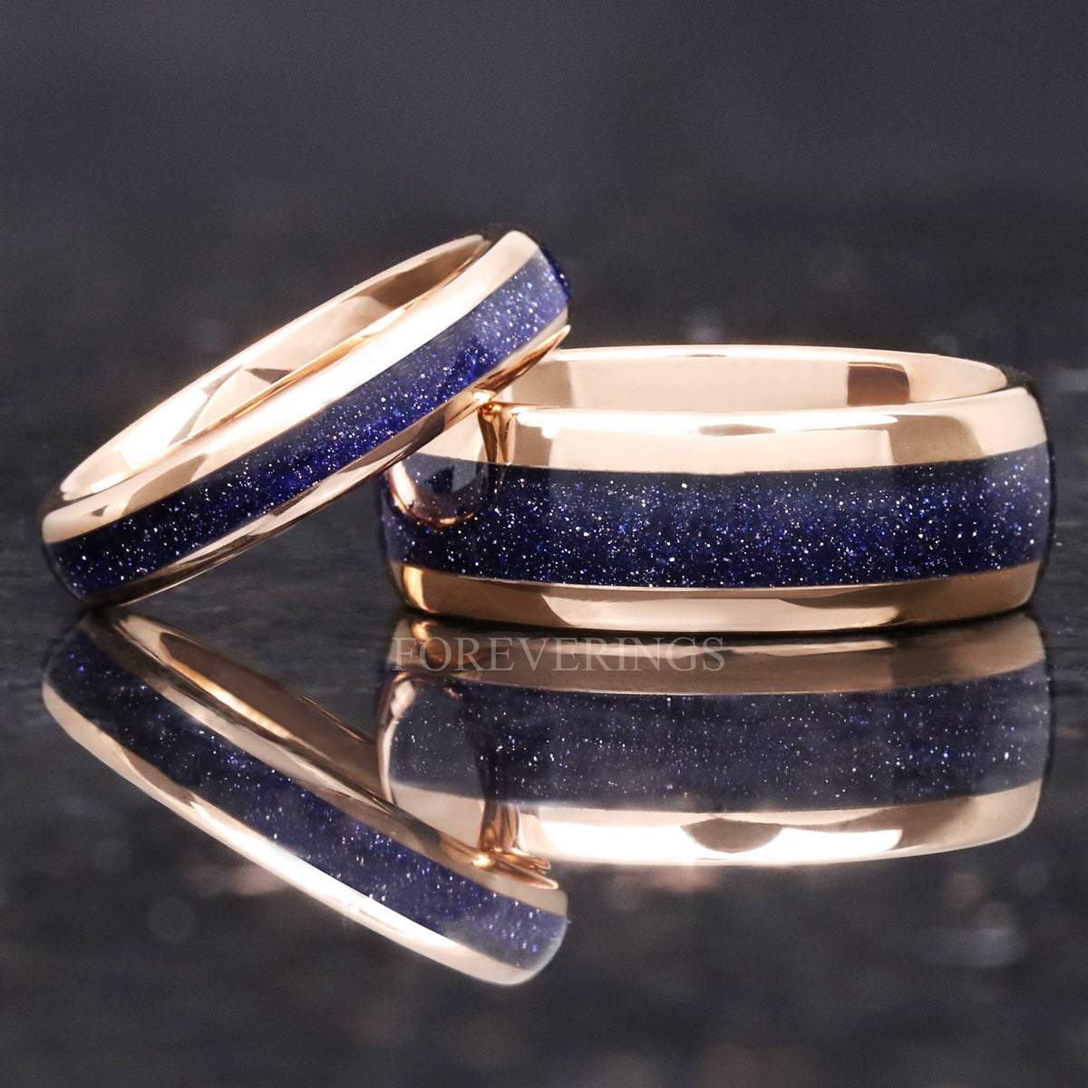 Narrow and wide rose gold tungsten bands with blue sandstone inlay, closer angled view