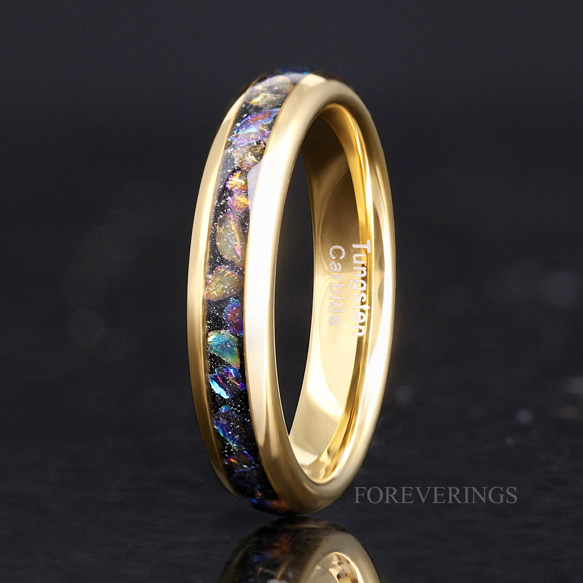 Her 4mm gold tungsten ring with moonstone inlay standing on edge