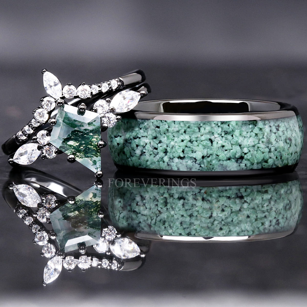 Wide black tungsten moss agate ring beside a moss agate engagement ring with white side stones