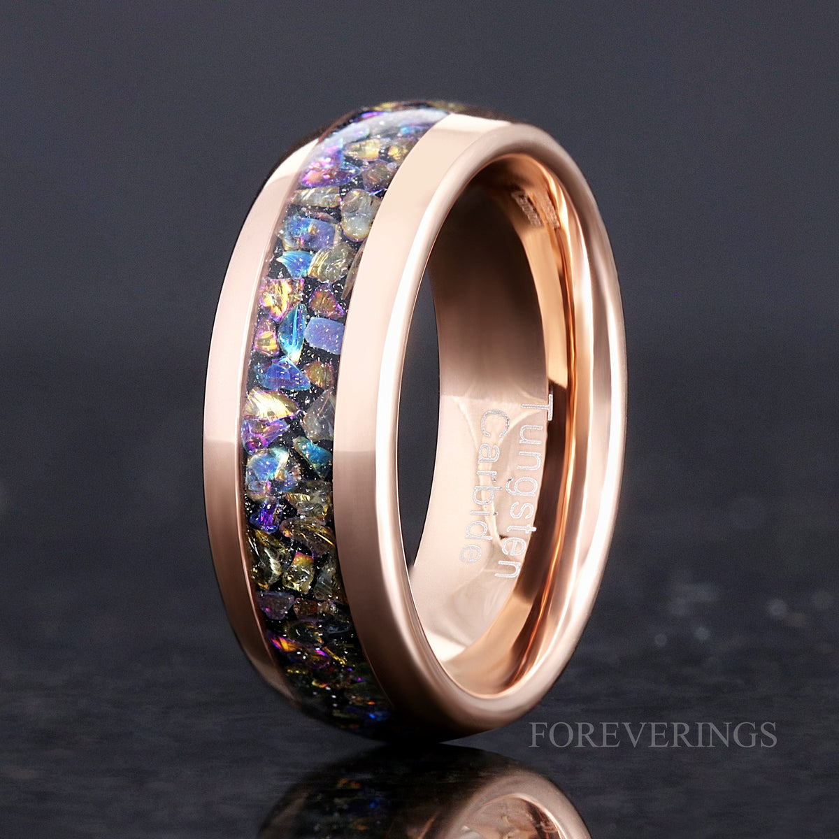 Men's 8mm rose gold tungsten ring with moonstone inlay, standing angled to show the interior