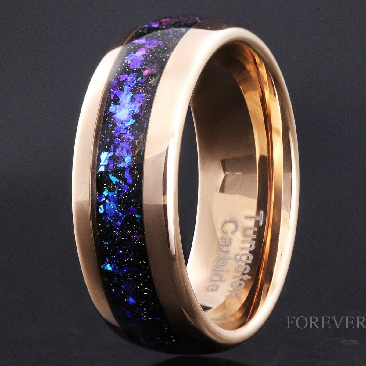 Rose gold tungsten wedding band with Orion nebula sandstone inlay, standing upright