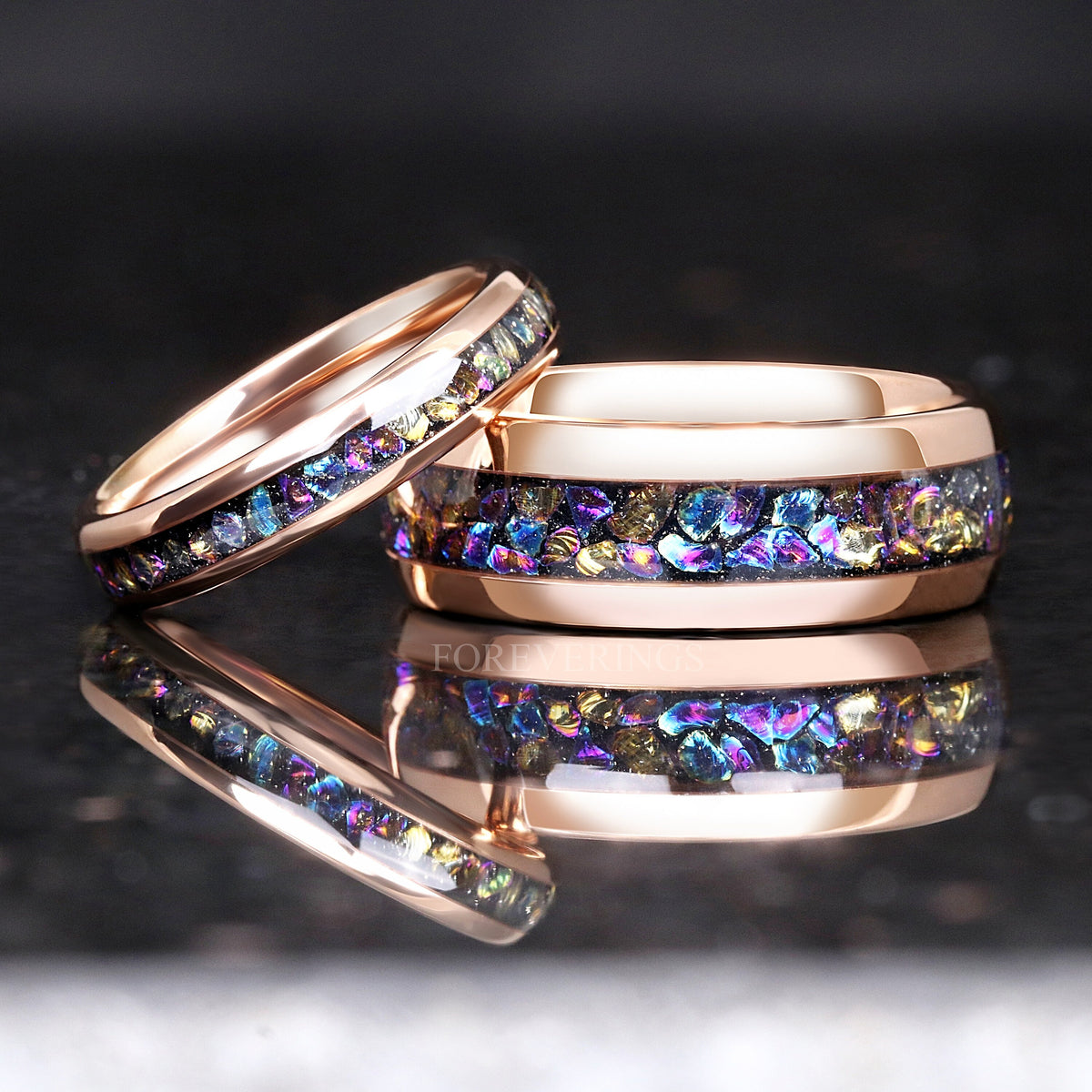 Two widths of the rose gold moonstone ring, the thinner one leaning on the wider