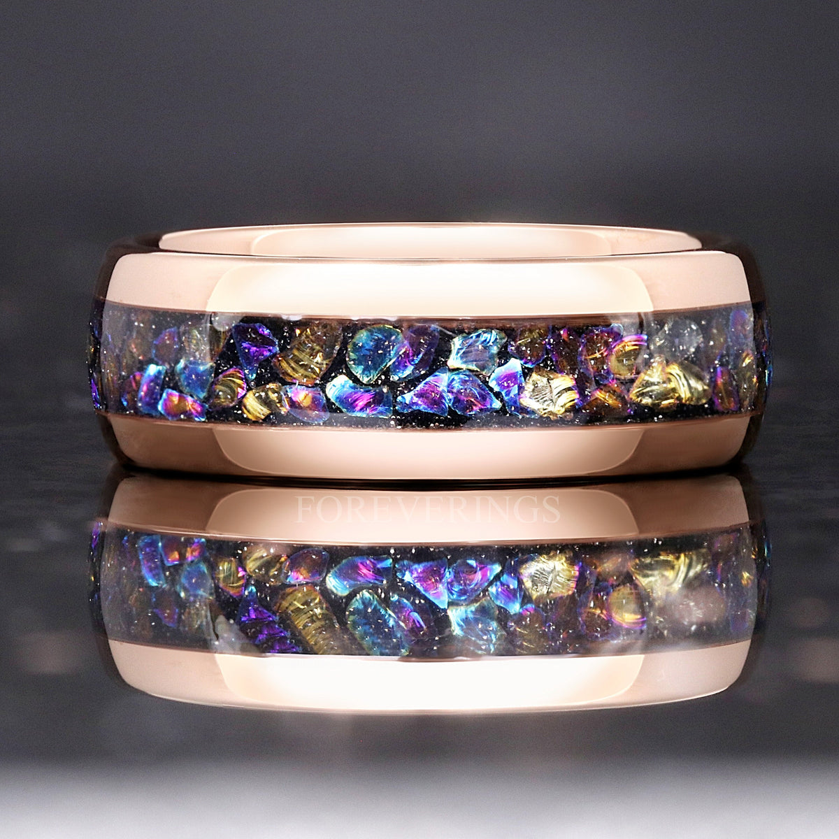 Rose gold tungsten moonstone ring lying flat, shown straight on with a reflection