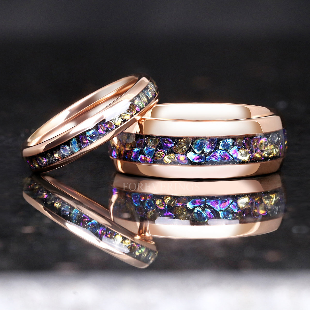 4mm rose gold moonstone ring leaning on a wider rose gold band with moonstone inlay