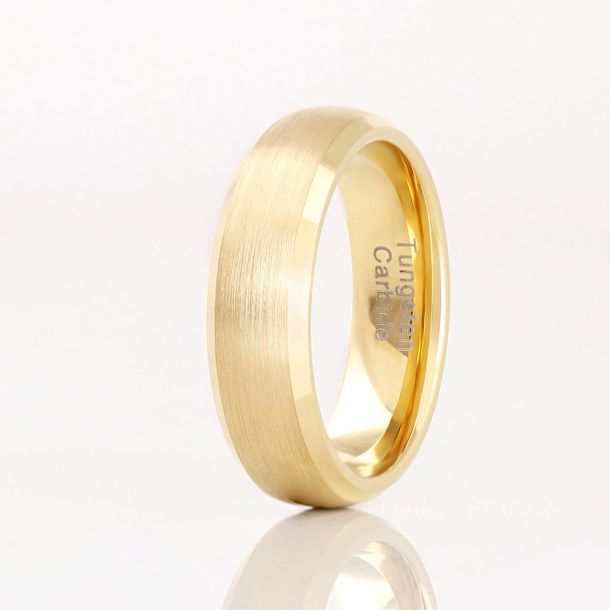 Men's 6mm brushed gold tungsten band with beveled edges, standing on edge