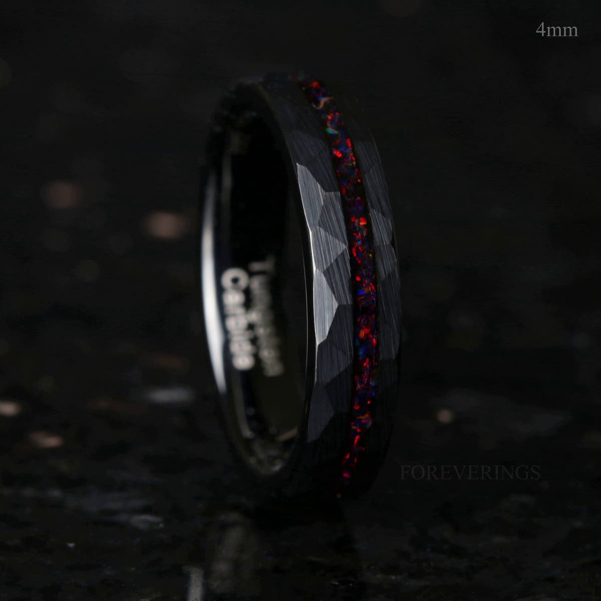 4mm black hammered tungsten ring with a black fire opal stripe, standing on edge
