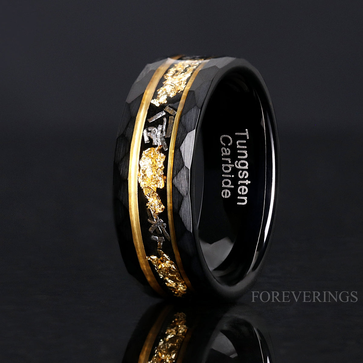 8mm black tungsten meteorite band with gold leaf, standing and angled in a wider view