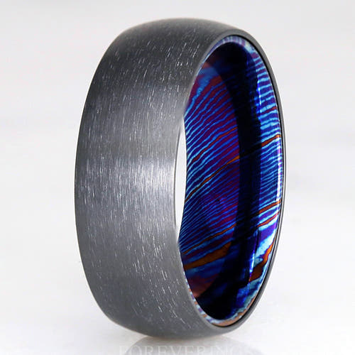 Men's 8mm brushed black zirconium wedding band with a blue Timascus sleeve inside