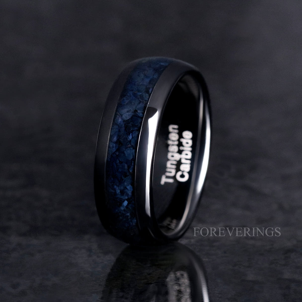 Men's 8mm black tungsten band with black onyx inlay, standing on edge