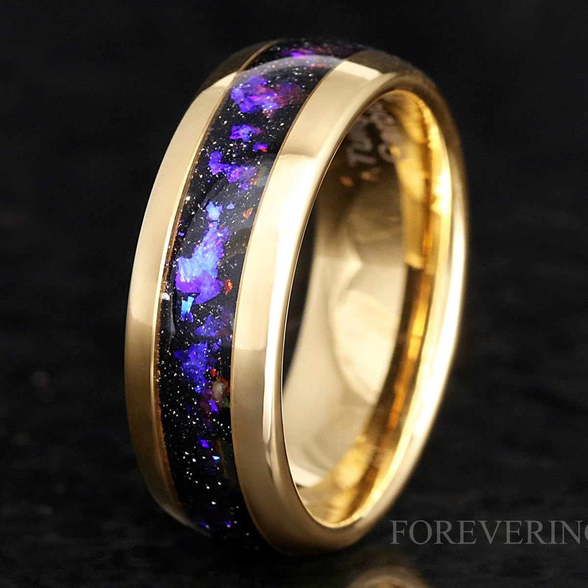 Gold tungsten wedding band with Orion nebula sandstone inlay, standing close-up showing the interior