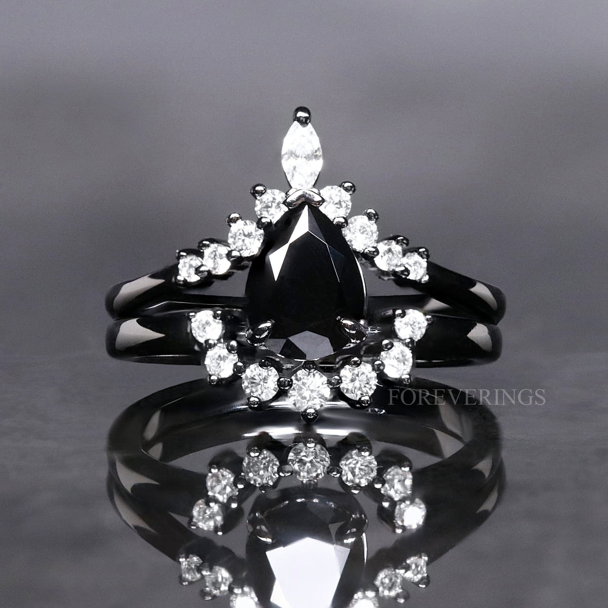 Pear-cut black onyx bridal set in black sterling silver with a curved halo band, front view