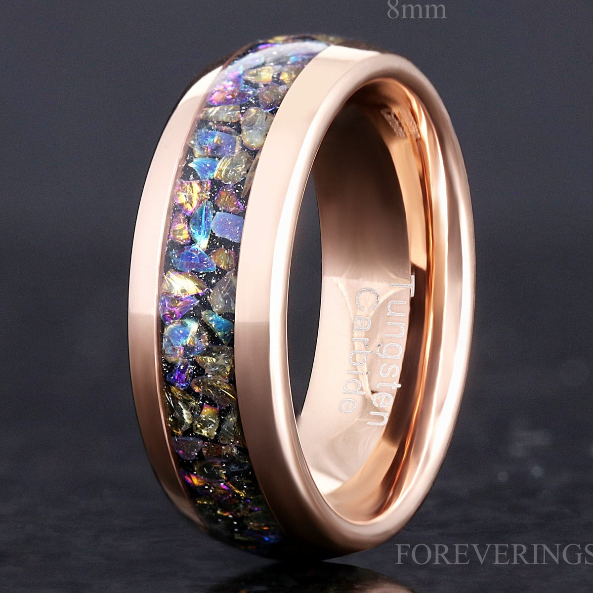 8mm rose gold tungsten wedding ring with Veil nebula moonstone inlay, standing at an angle