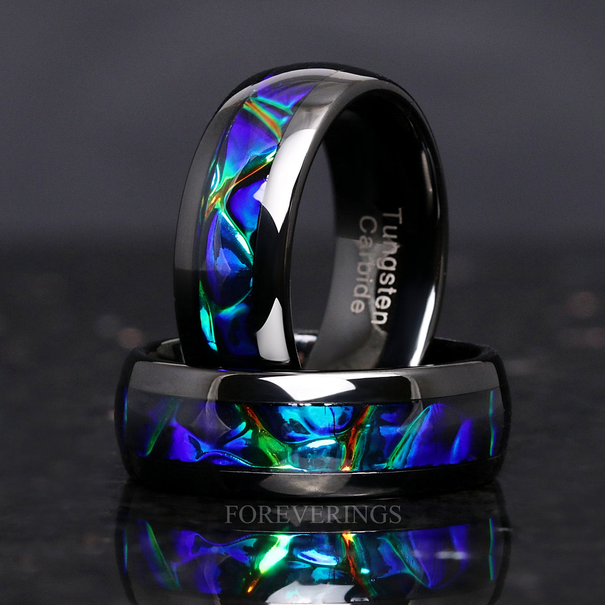 Two black tungsten azure inlay bands, one standing behind the other lying flat