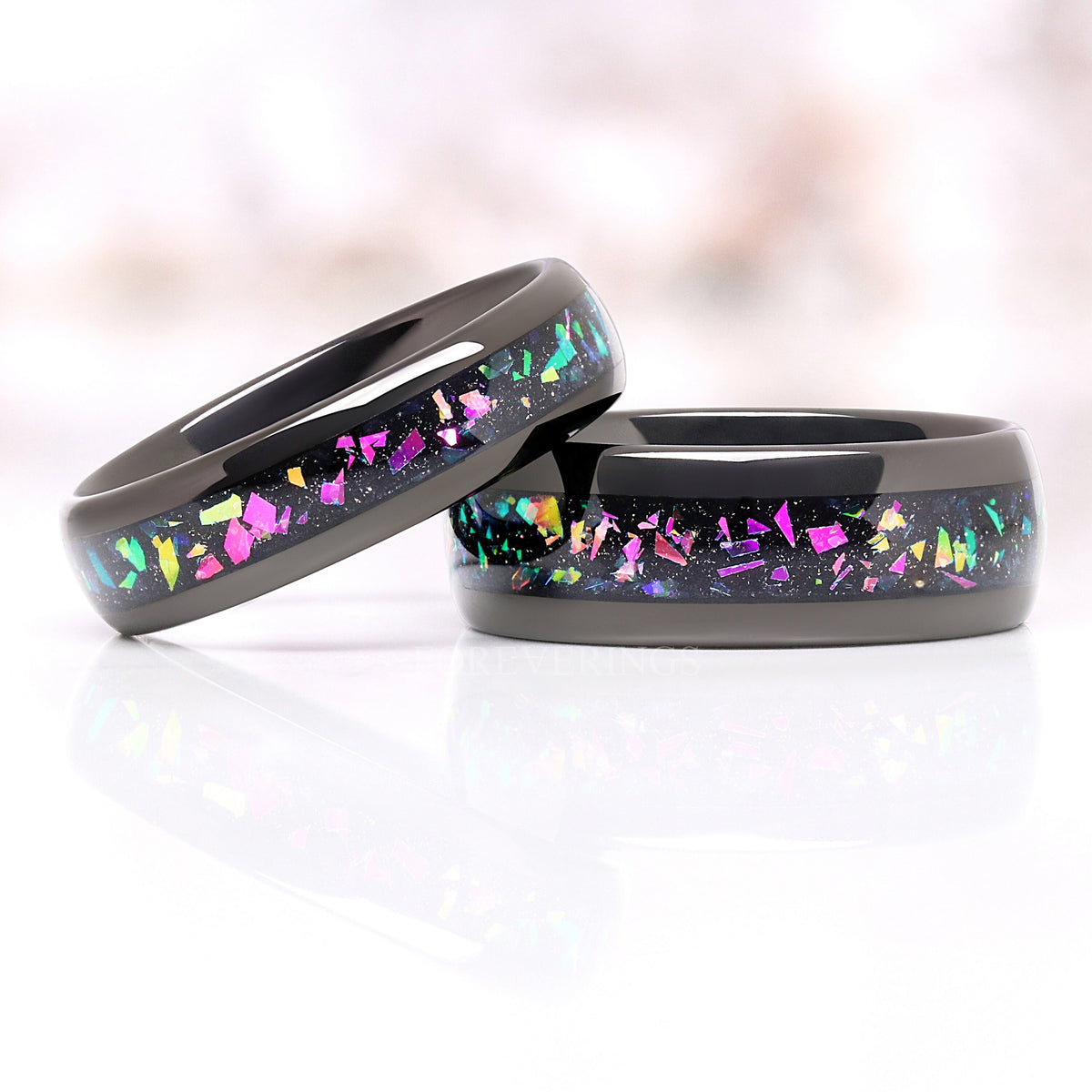Mid-width black supernova band leaning on a wide one with the same color-changing inlay