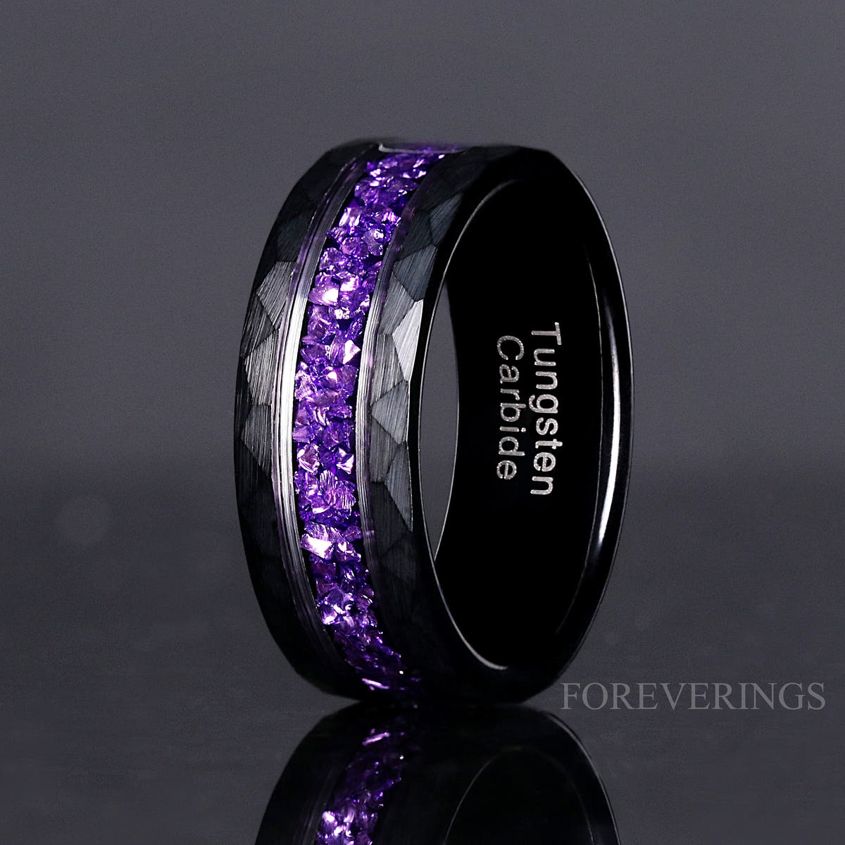 8mm hammered black tungsten ring with amethyst inlay standing upright, close crop