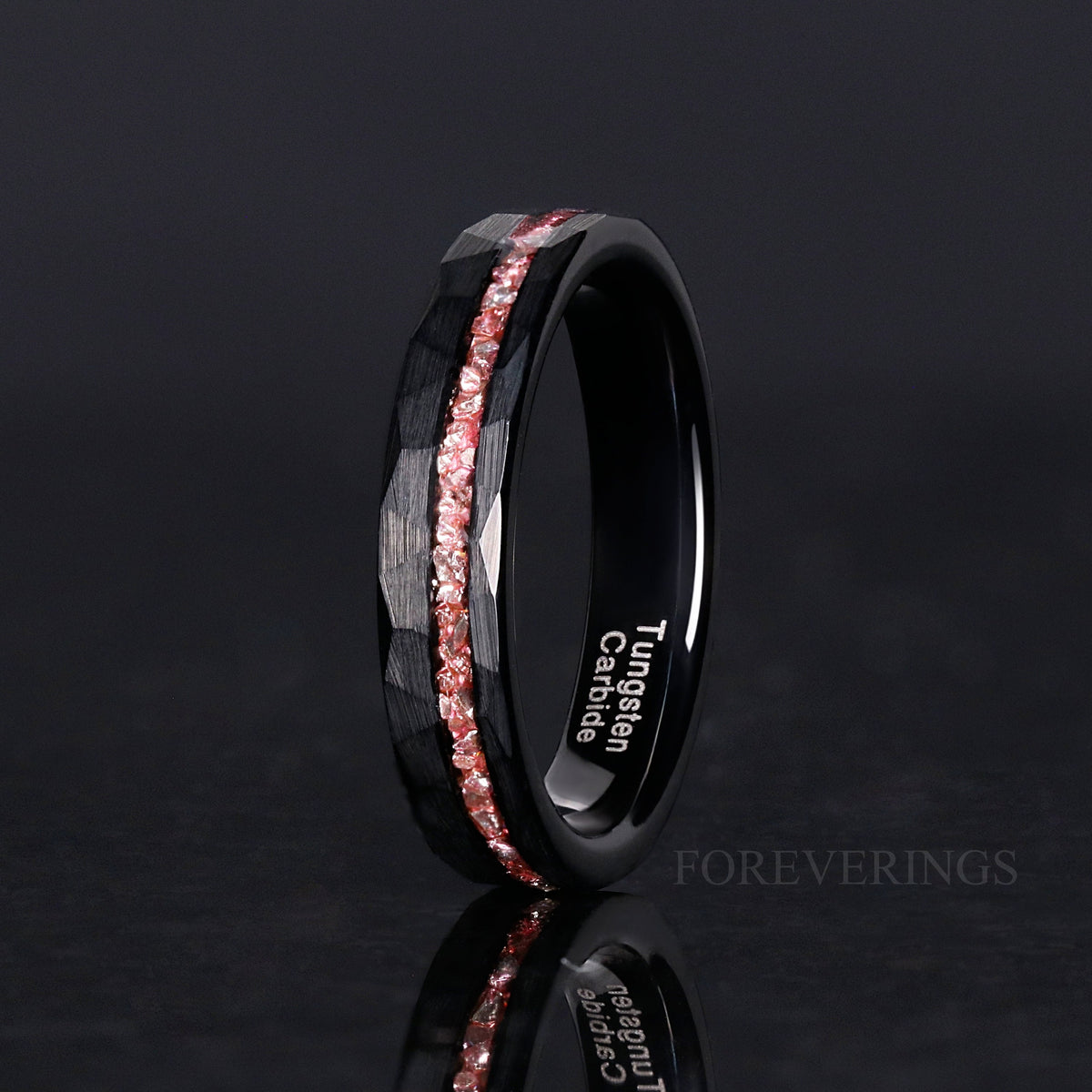 Women's 4mm black hammered tungsten ring with a pink morganite strip, angled view