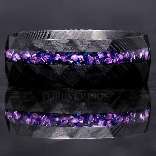 Men's 8mm black Damascus steel ring with alexandrite and purple sandstone inlay, shown straight on