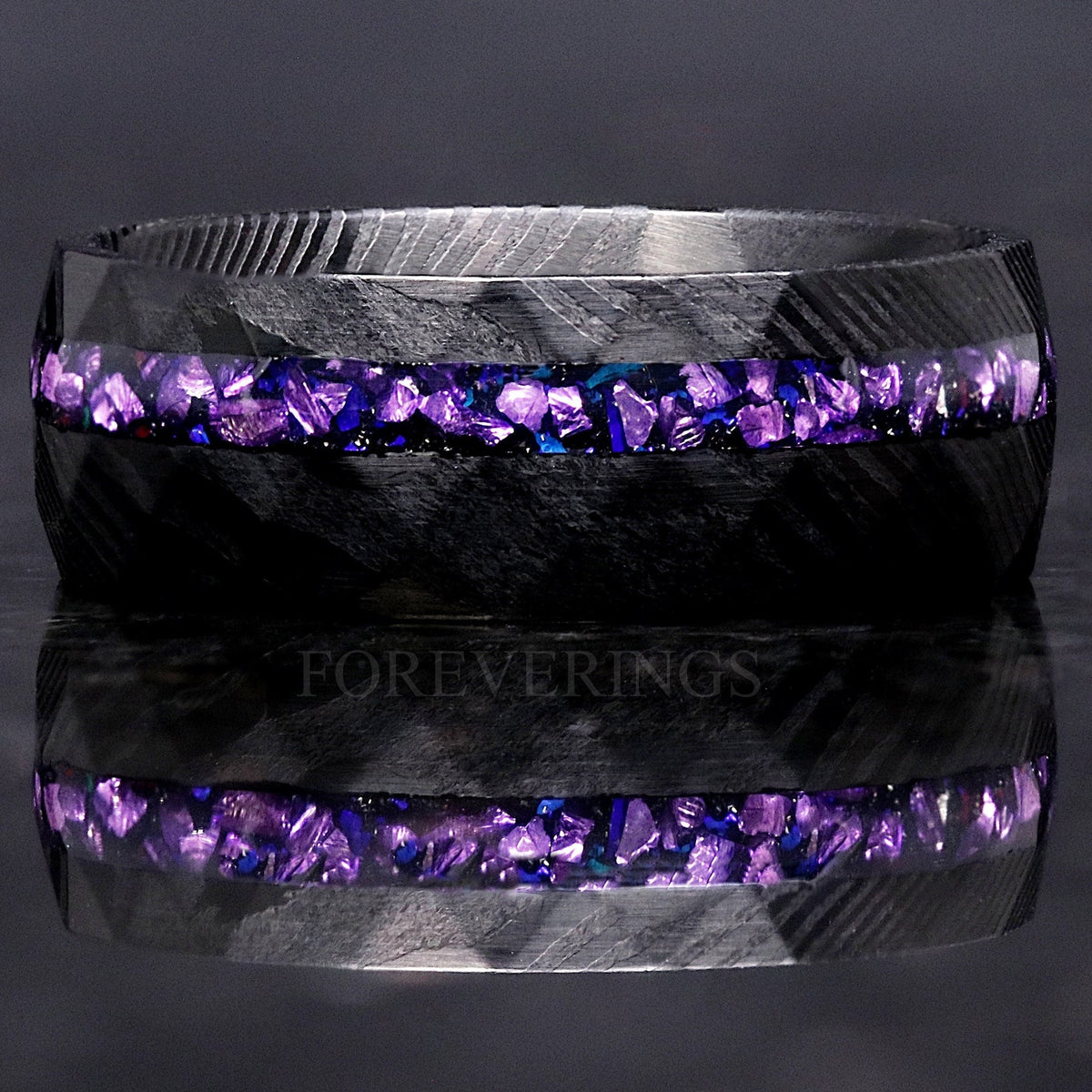 Men's 8mm black Damascus steel ring with alexandrite and purple sandstone inlay, shown straight on