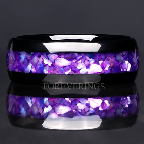 Men's 8mm black tungsten wedding band with purple glow-in-the-dark stone inlay, close-up