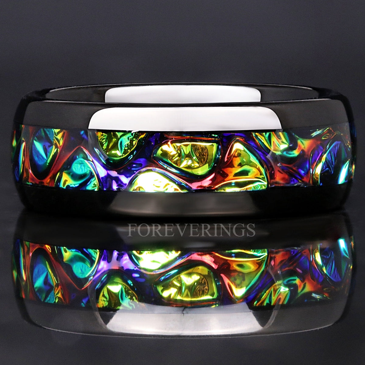 Men's 8mm black tungsten band with green dichrolam inlay, lying flat with a reflection